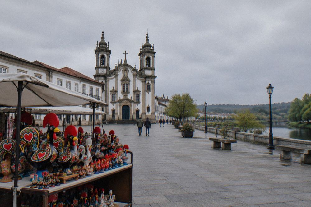 A stall of brightly painted ceramic roosters at an outdoor market in Barcelos