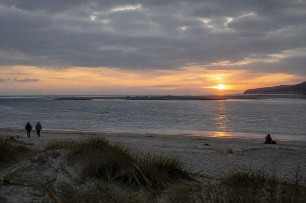Sunset over the Atlantic horizon seen from the sand at the mouth of the Minho River