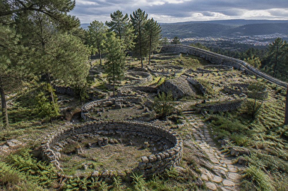 Granite defensive wall curving across the hilltop settlement