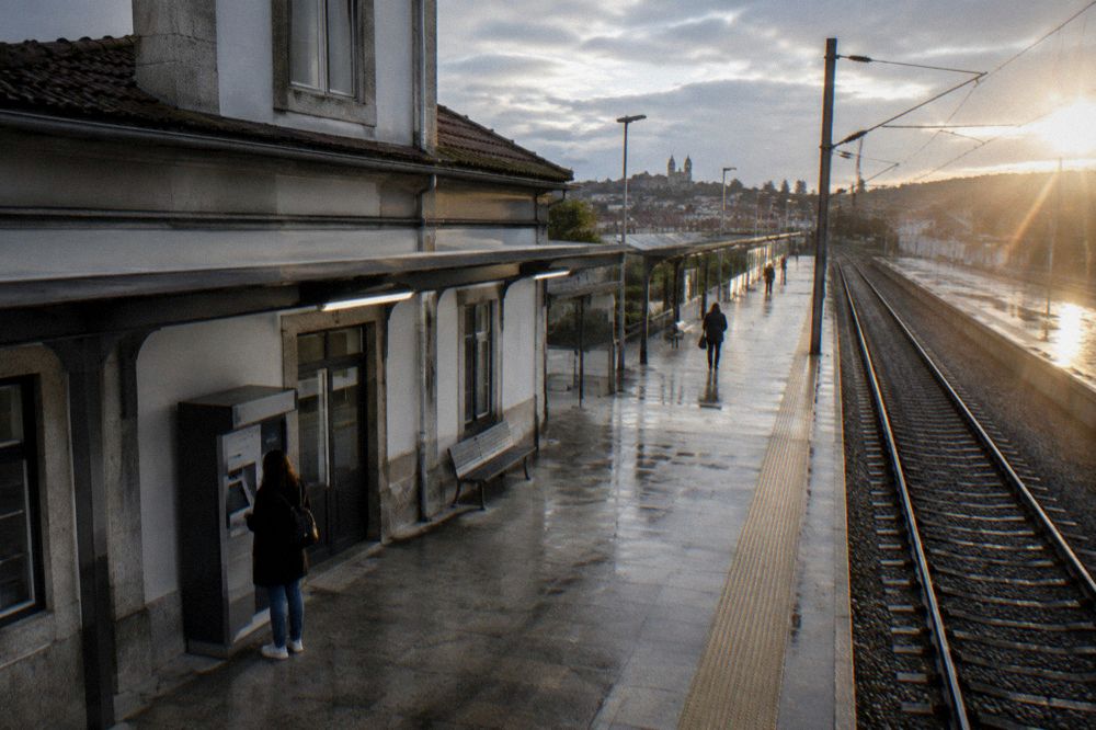 A traveller checking a ticket machine at a Portuguese train station