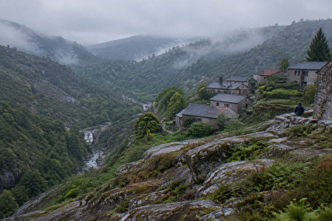 A granite outcrop above a green forested valley in Peneda-Gerês National Park