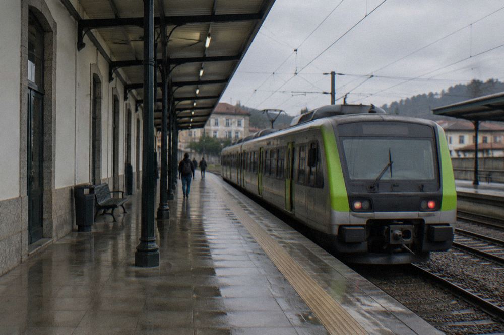 A CP urban train waiting at a platform under a station canopy in northern Portugal
