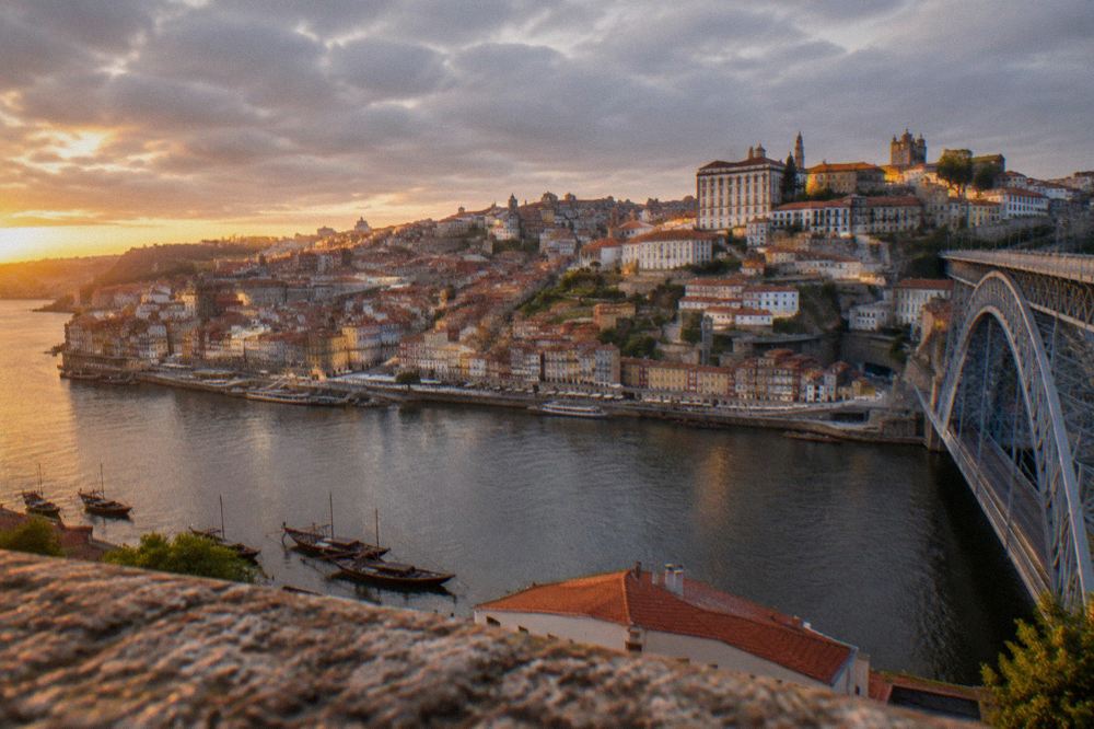 Sunset light on the rooftops and church towers of Porto seen from a high viewpoint