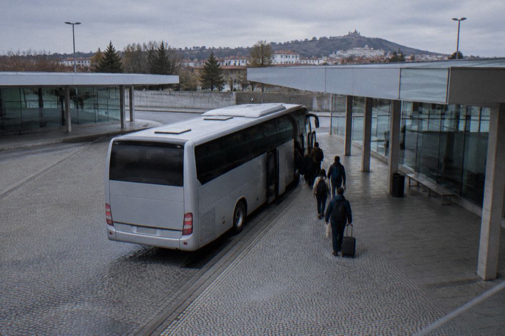 Intercity coach parked at a Portuguese bus station with passengers boarding