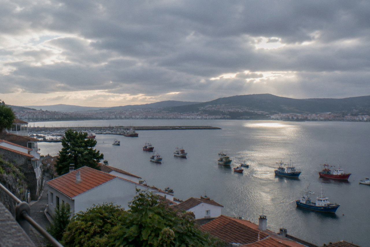 A view over Vigo's harbour and ria with fishing boats and green hills behind