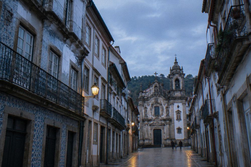 Narrow granite streets and balconied houses in Vigo's old town above the harbour