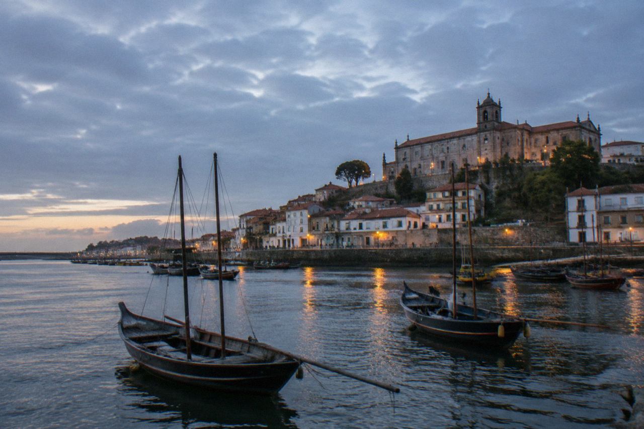 The river mouth and riverside buildings of a small northern Portuguese coastal town at dusk