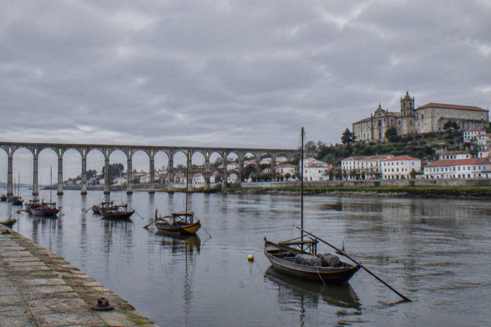 A long granite aqueduct with rows of arches crossing a town in northern Portugal