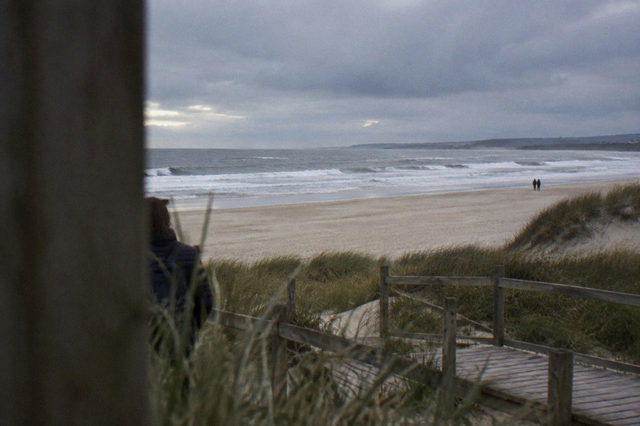 Wide sandy beach with rolling Atlantic waves and a line of dunes along the northern Portuguese coast