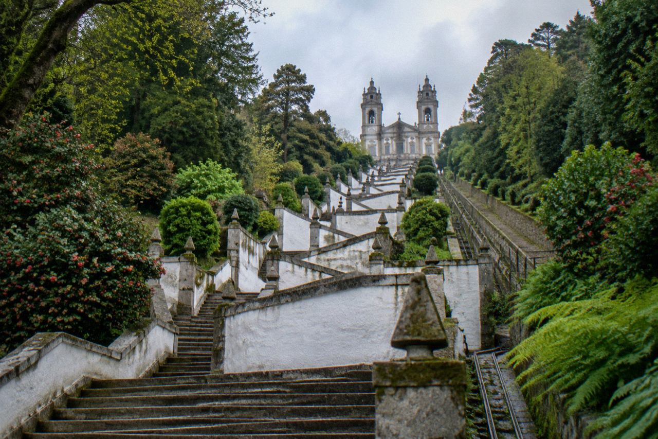 The Bom Jesus do Monte sanctuary stairway rising through green woodland above Braga on a bright morning