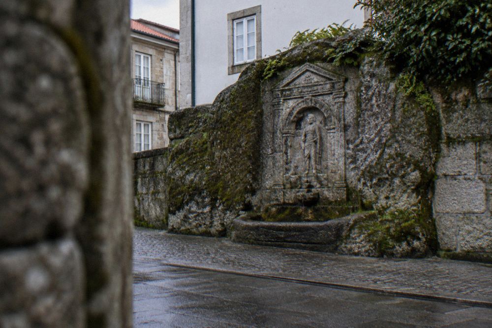 A carved granite relief of the Roman fountain monument Fonte do Ídolo in Braga