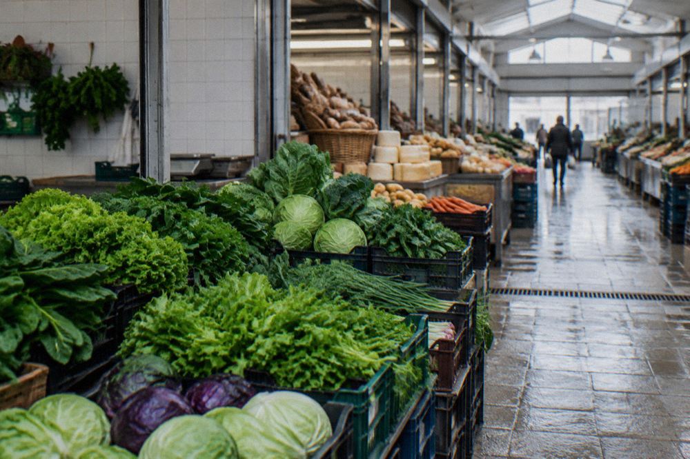 Stall of leafy greens and cabbages stacked in crates at a Portuguese market