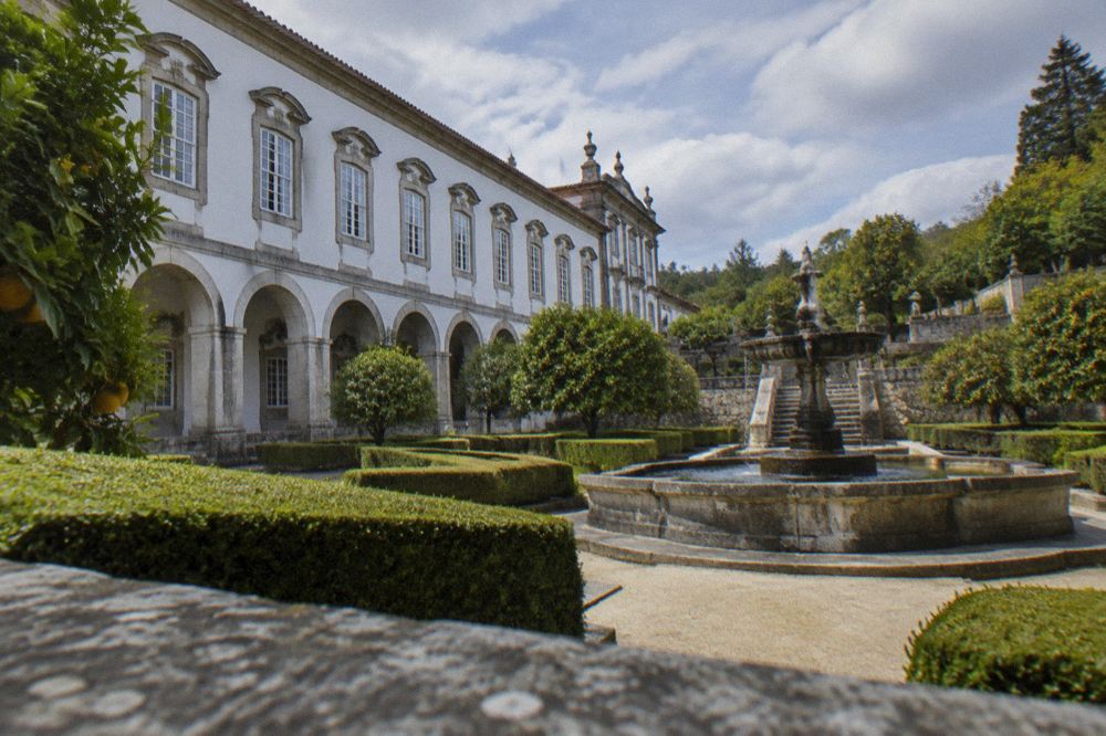 Tiled interior courtyard of a Portuguese baroque palace museum with stone arches