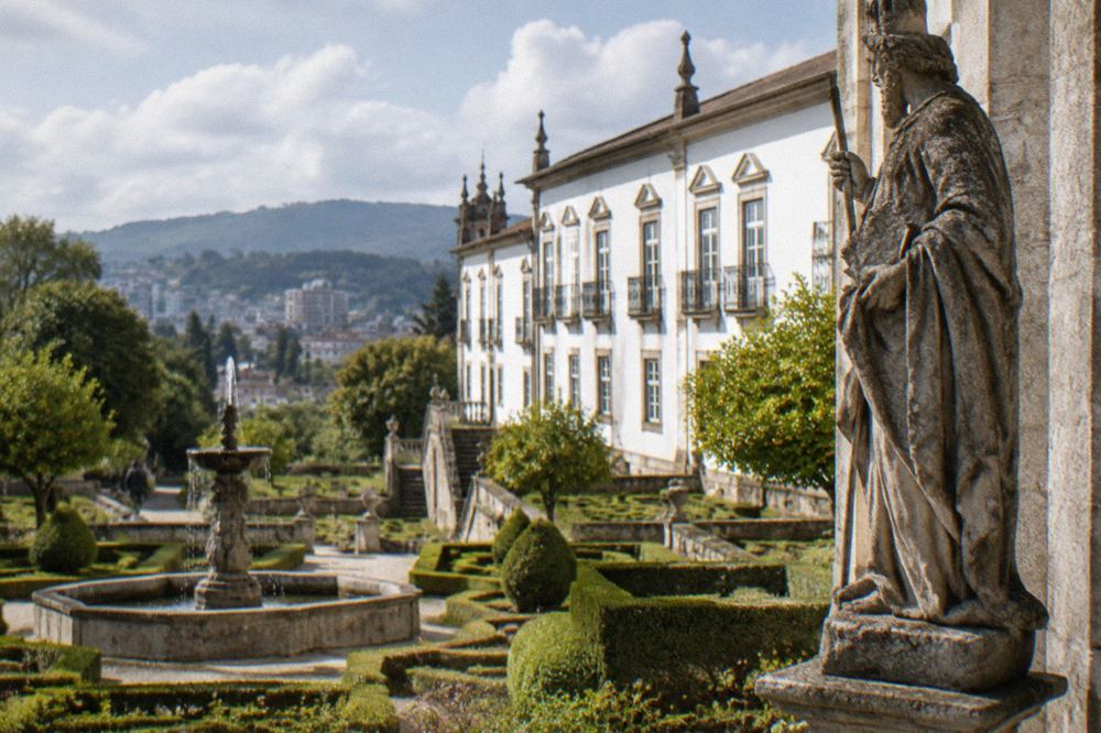 Carved granite saint sculpture displayed inside a Portuguese museum gallery
