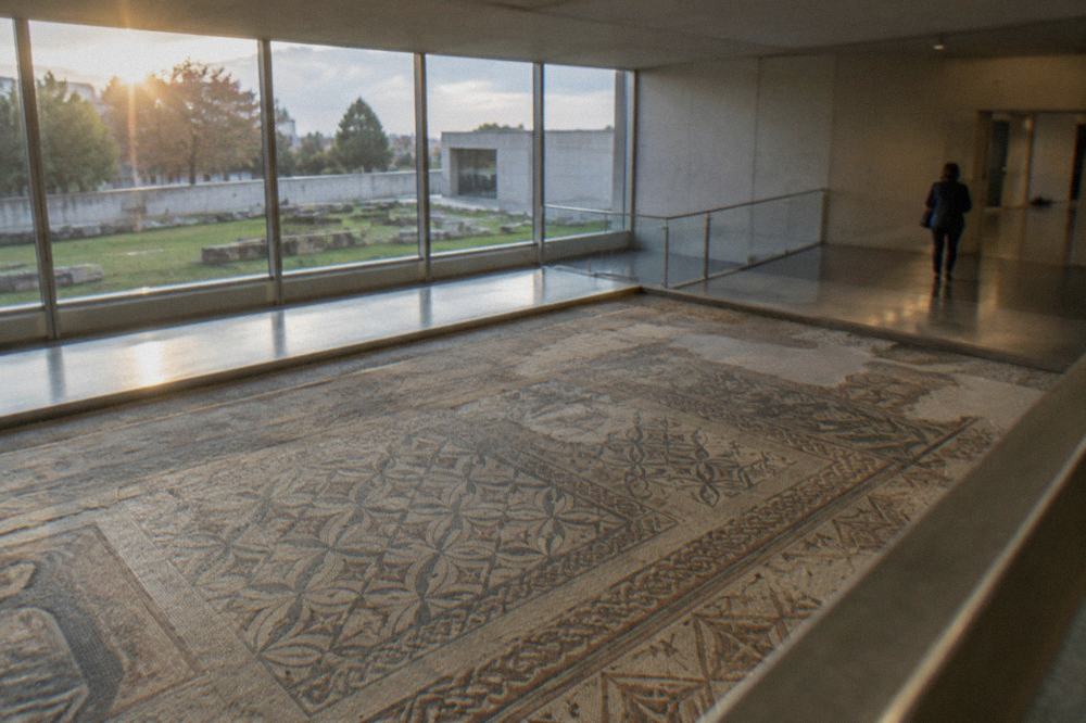 Roman mosaic floor displayed in a bright archaeology museum gallery