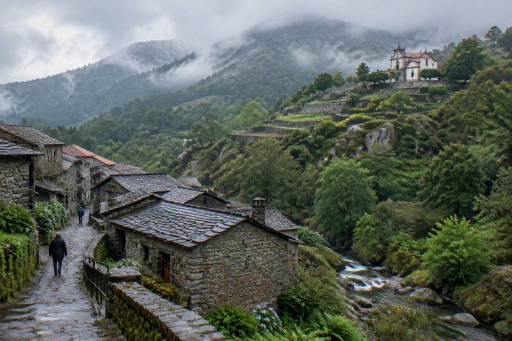 Sunlight over the terraced gardens of a hillside sanctuary above a Portuguese city