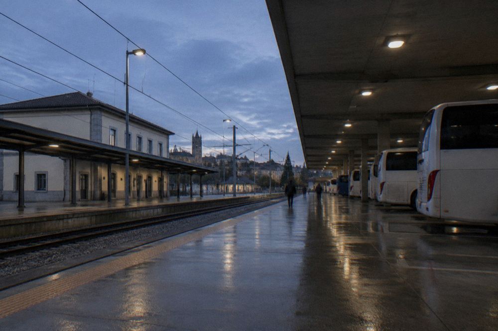 The covered platform area of a Portuguese intercity bus station with coaches at their stands