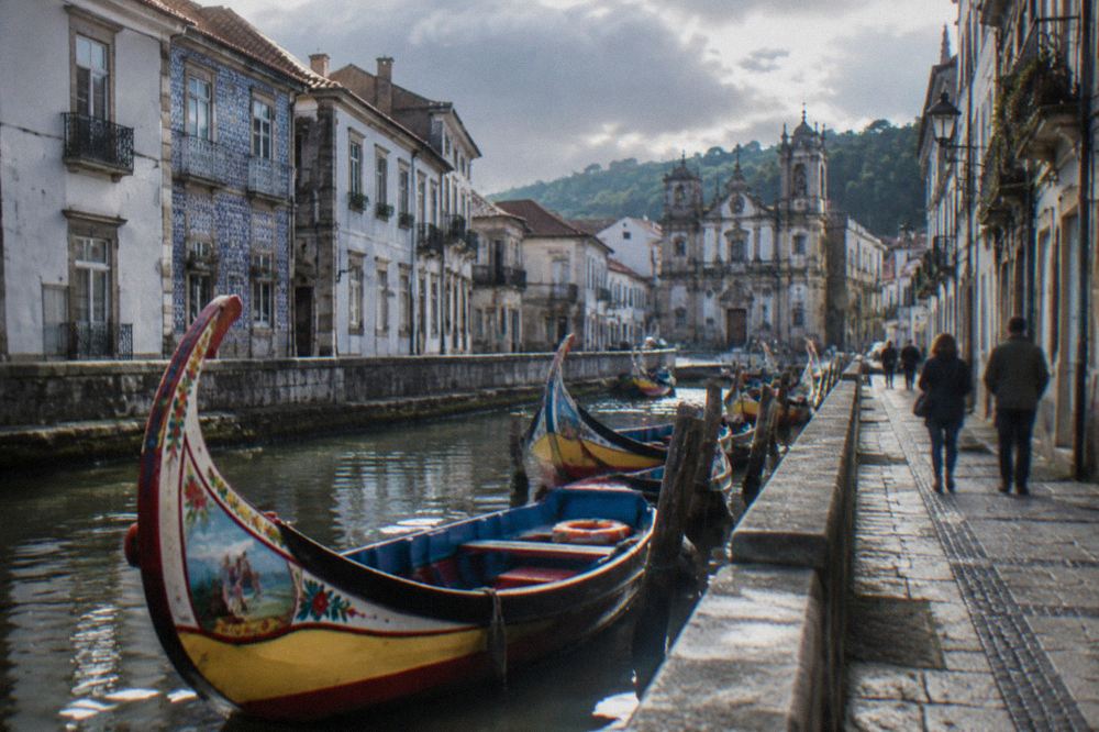 Colourful moliceiro boats moored along one of Aveiro's canals