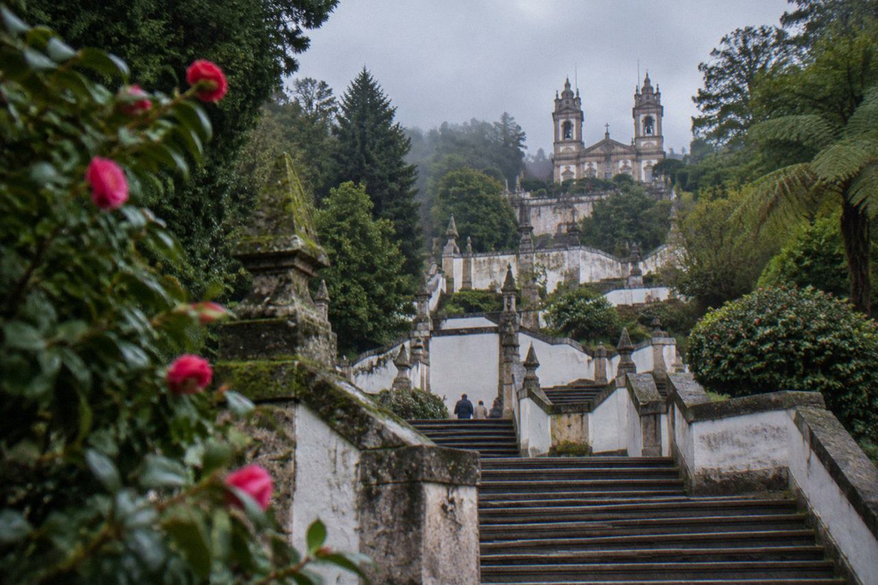 Baroque stairway and sanctuary terraces rising above wooded hills at Bom Jesus do Monte near Braga