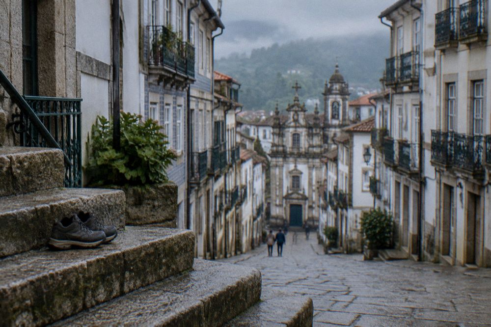 A pair of walking shoes on worn granite steps in Braga
