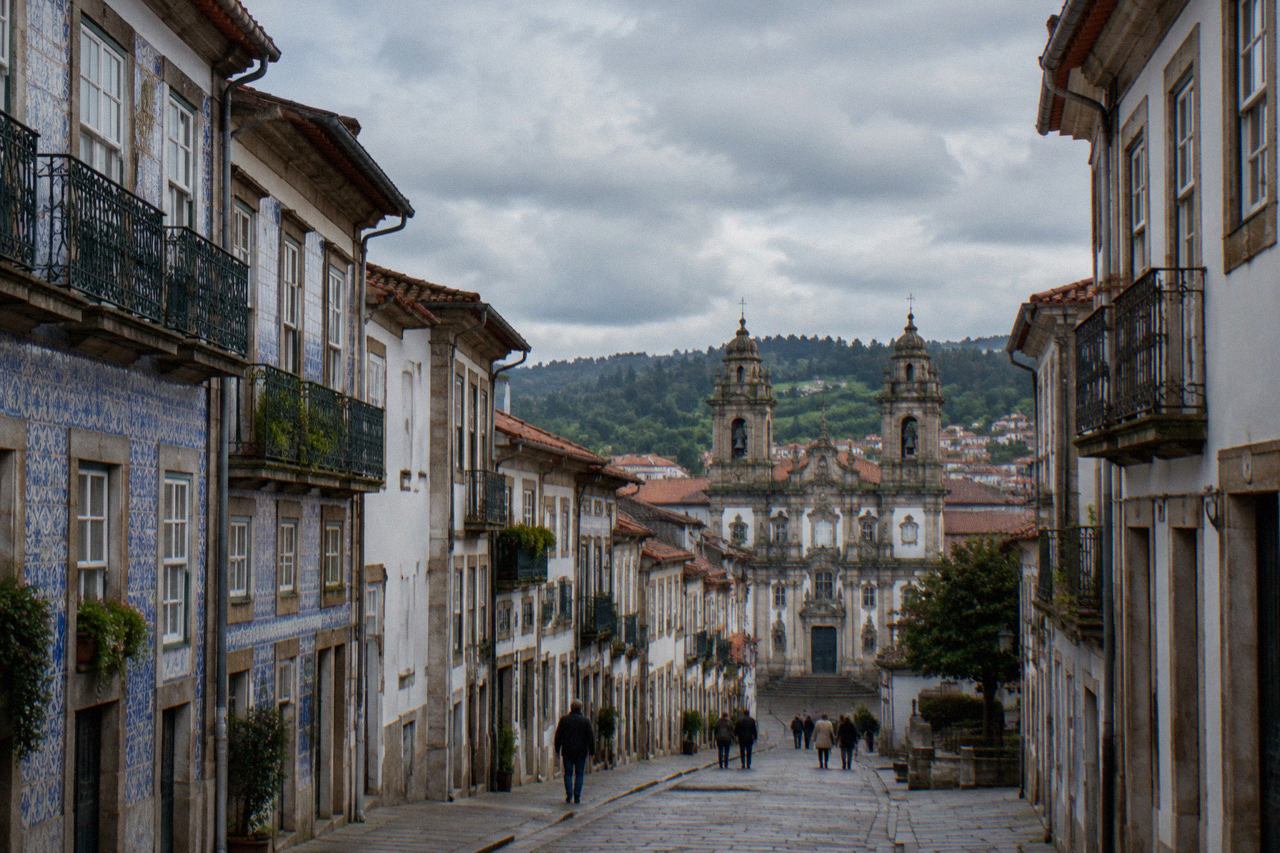 A view over the historic centre of Braga with baroque church towers under a partly cloudy sky