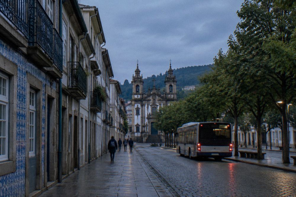 A city bus on a tree-lined avenue in Braga under an overcast sky