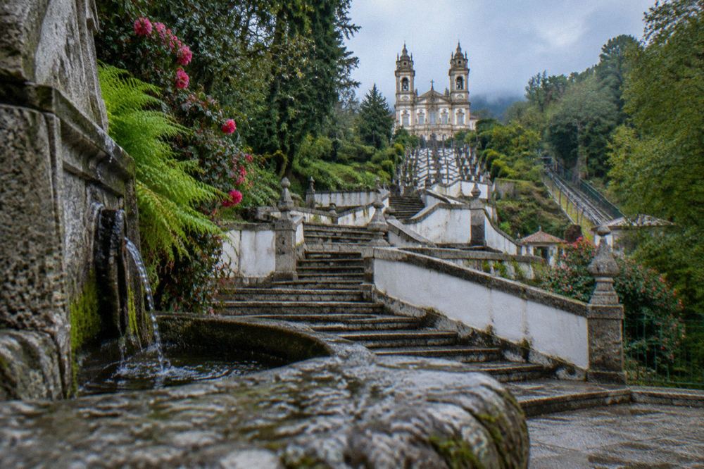 Stone steps of the pilgrimage stairway curving past a fountain at Bom Jesus do Monte