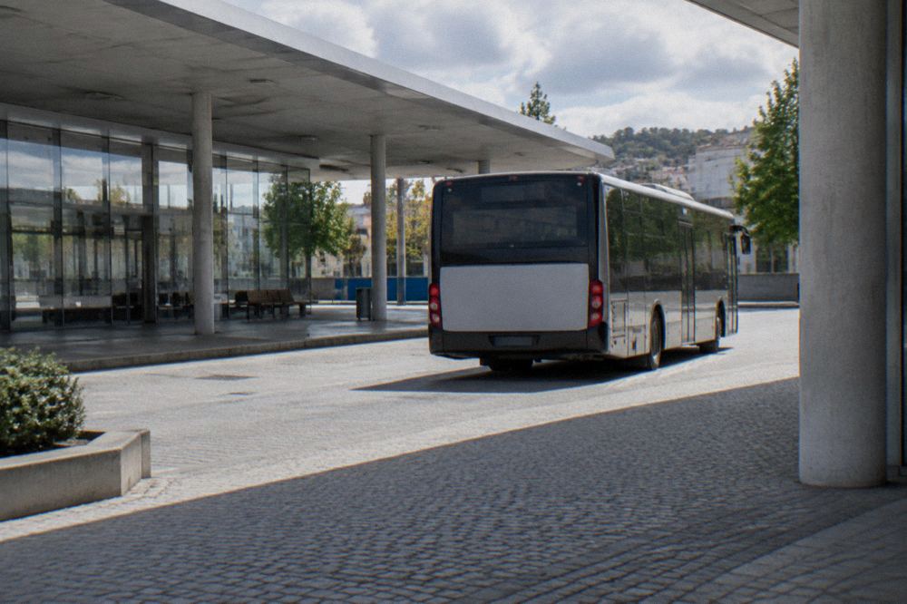 A regional bus pulling out of a small city bus station in Portugal
