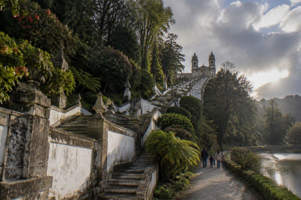 Families walking through a garden path near the Bom Jesus lake