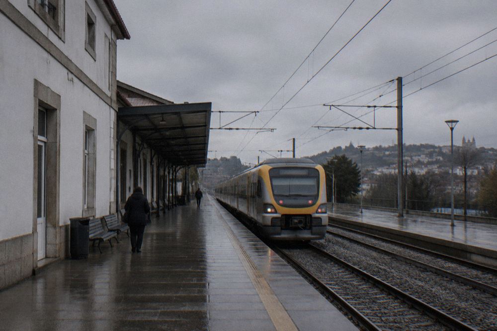 A train waiting at a platform in a Portuguese station