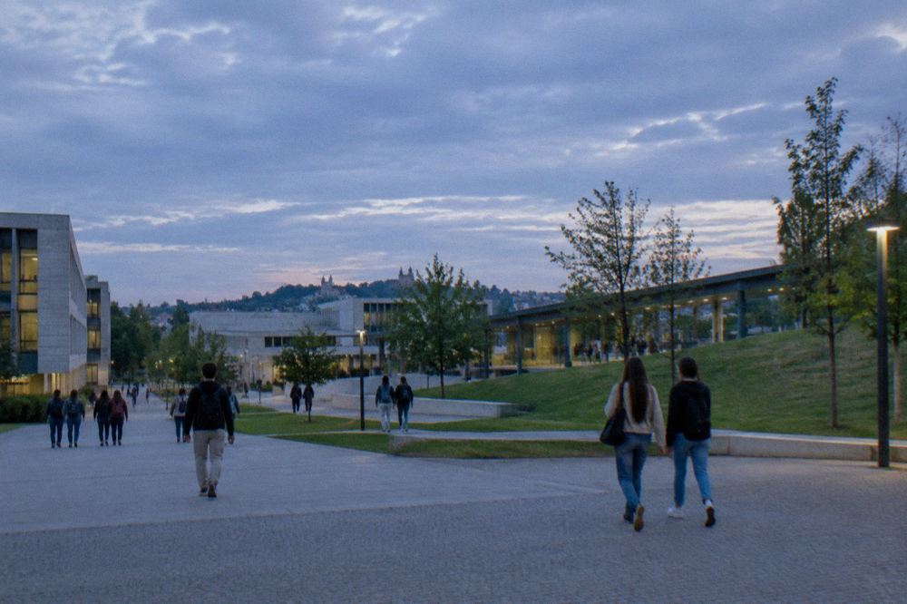 Students crossing a university campus plaza in Braga on a mild day
