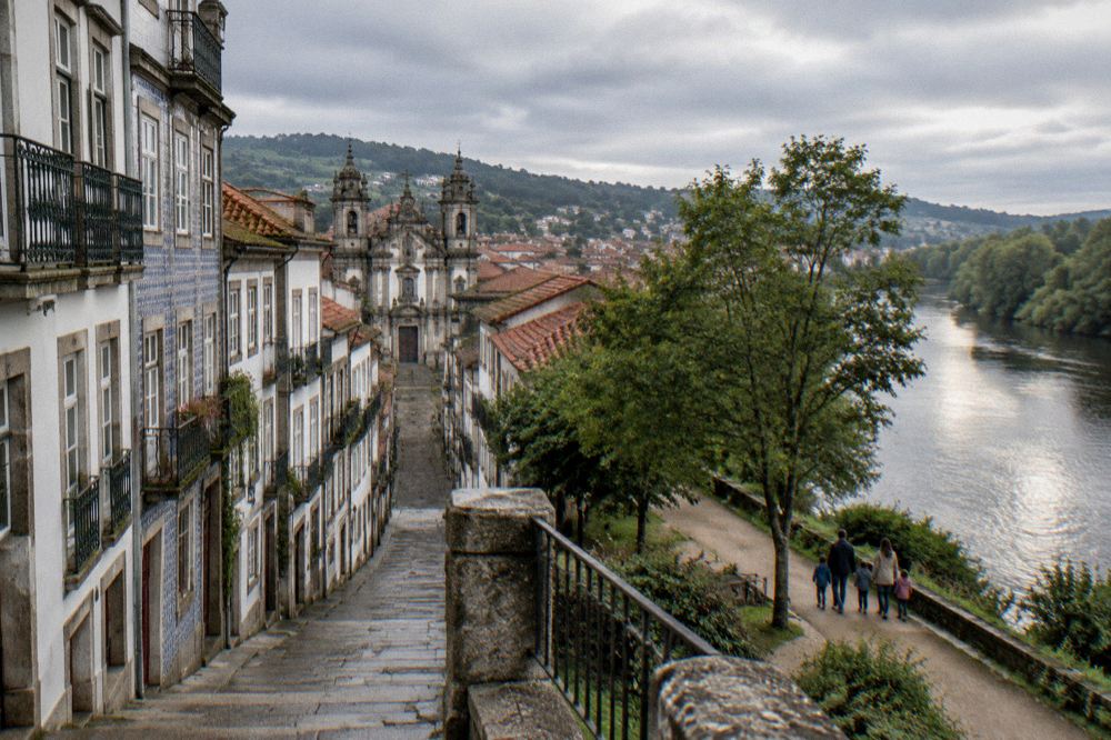 A family walking a riverside path in the Minho countryside near Braga