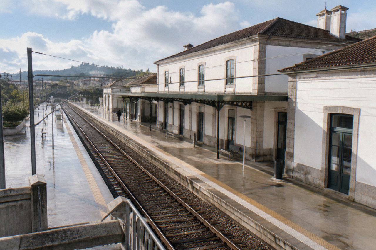 A CP regional train at a station platform in northern Portugal on a bright morning