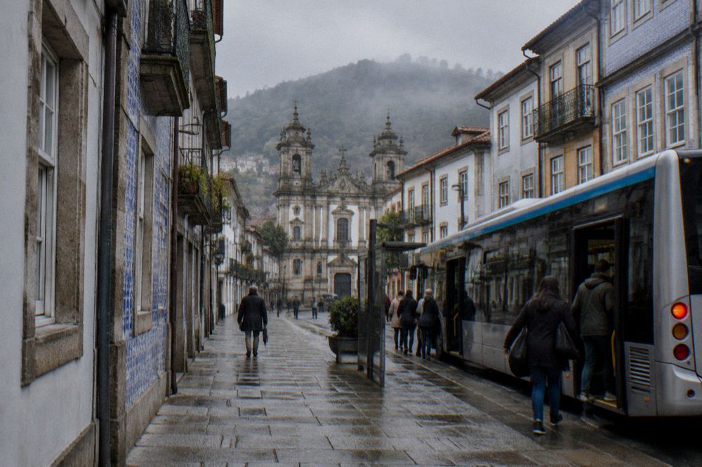 City bus waiting at a stop in Braga with passengers boarding