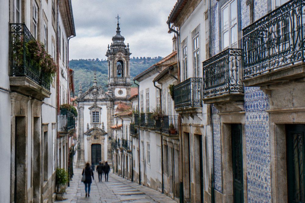 Baroque church tower rising above tiled rooftops in Braga's historic centre