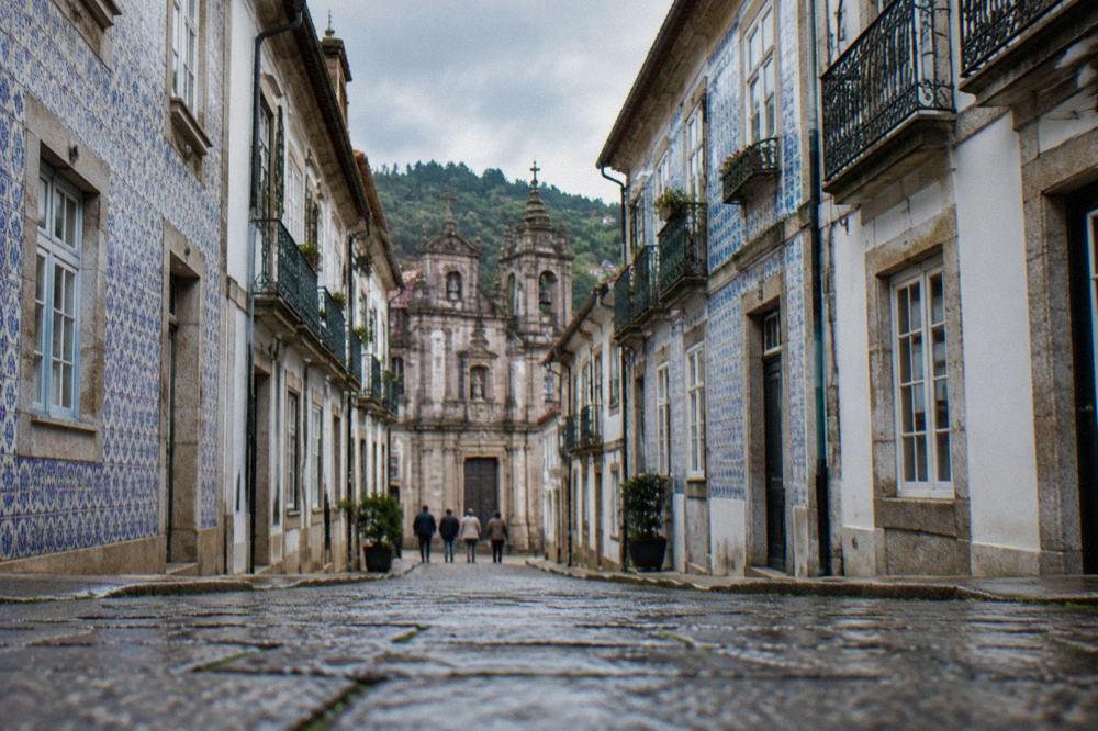 The narrow medieval streets and historic buildings of Guimaraes old town on a bright day