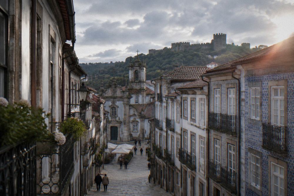 The medieval castle walls of Guimarães above the historic town centre