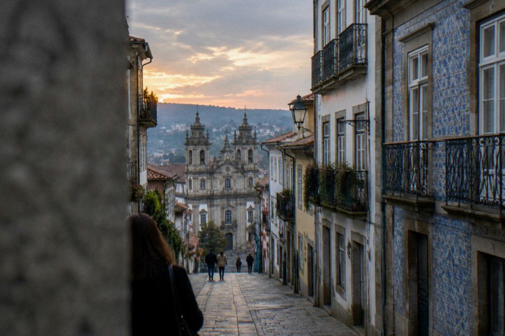 Sunset light over the rooftops and church towers of Braga seen from a hillside viewpoint