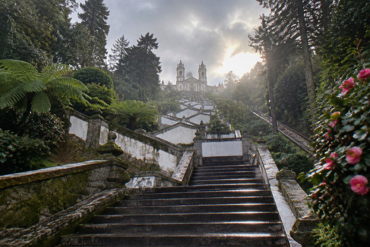The baroque stairway of Bom Jesus do Monte rising through green woodland above Braga