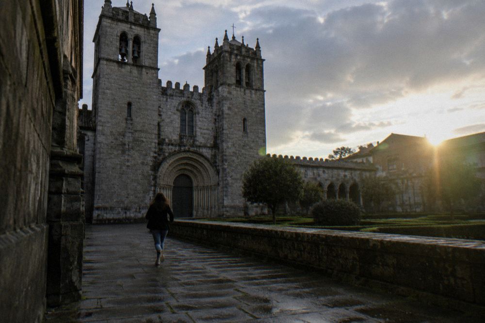 The Romanesque south portal and twin towers of Braga Cathedral seen from the square